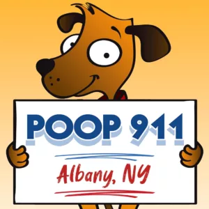 POOP 911 Albany, NY yard sign being held by a smiling brown dog.