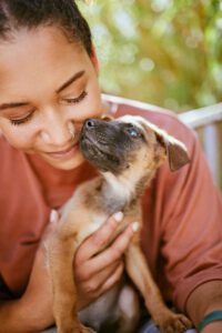 Why dog owners are happier people. A woman and her puppy bonding.