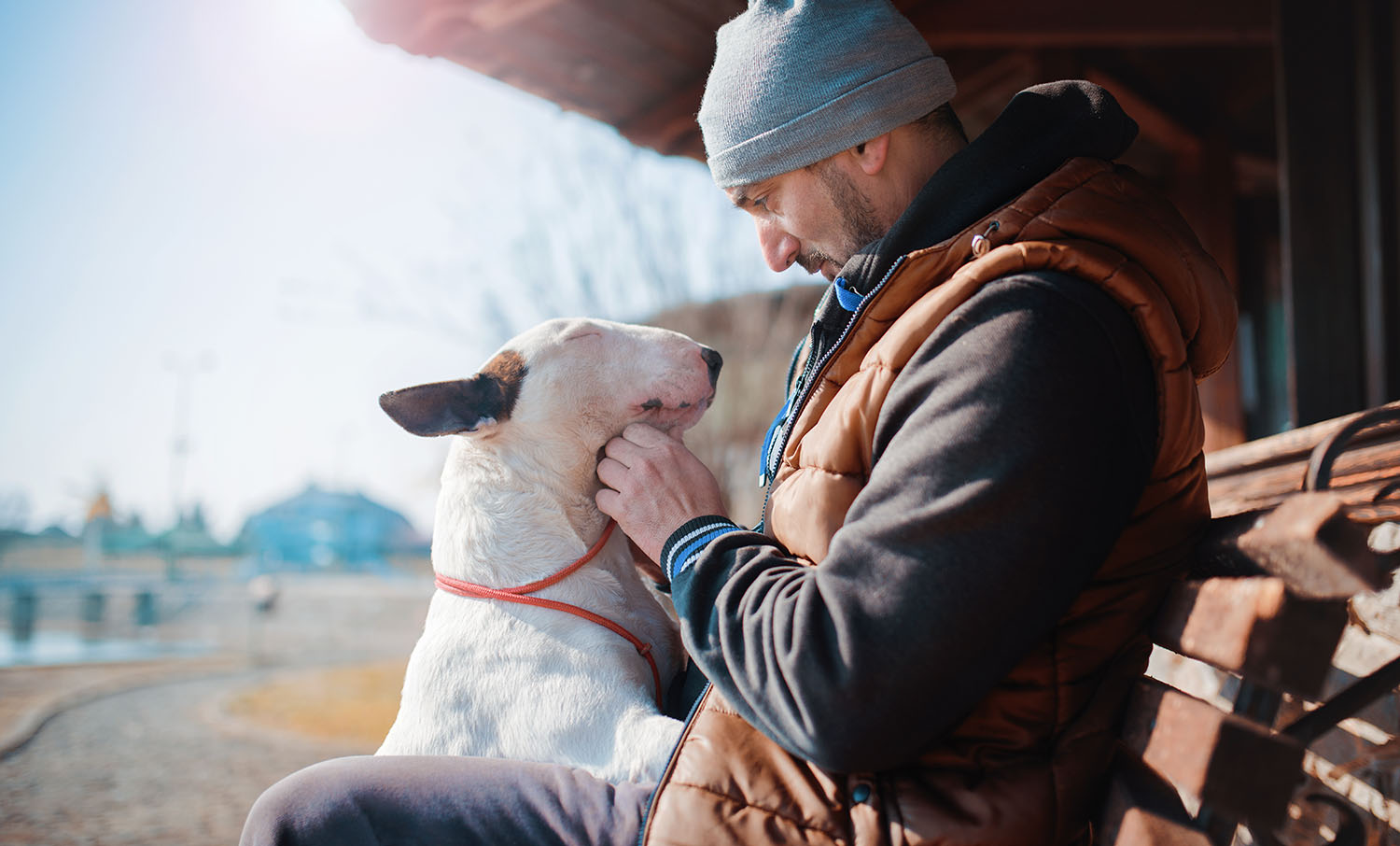 Why are dog owners happier people? A man bonding with his dog.